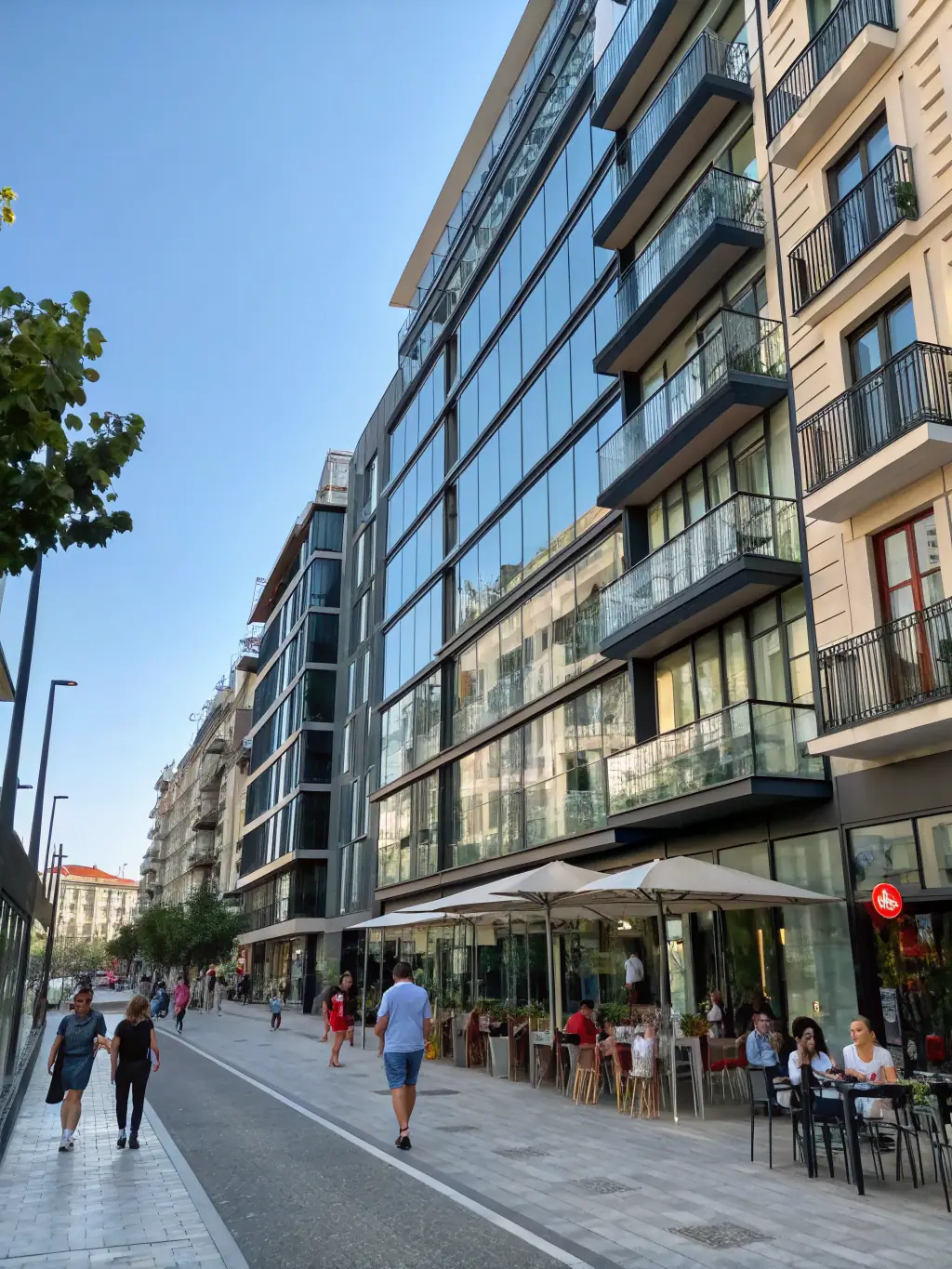 A modern apartment building in Madrid with large windows and balconies, showcasing urban living.